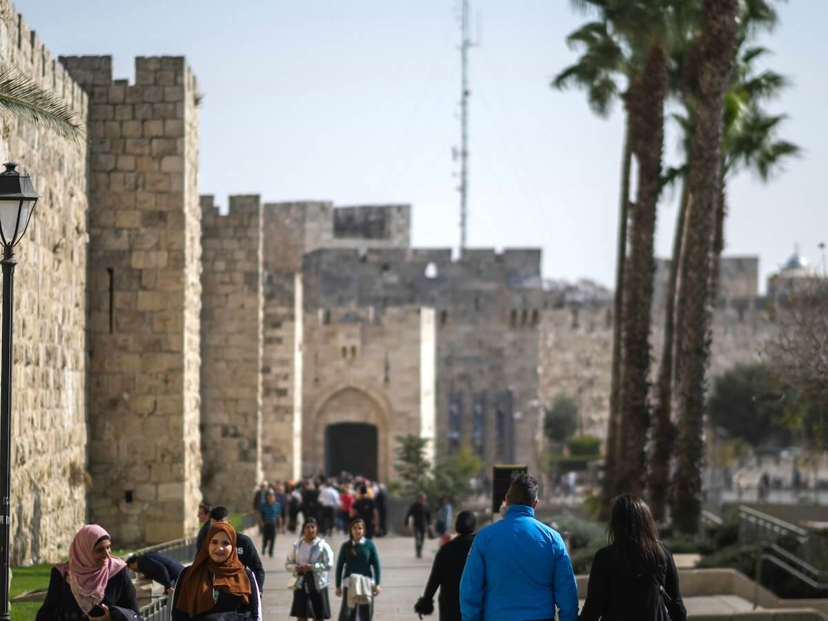 People walking in and out of Jaffa Gate in Jerusalem - a gate into the Old City walls