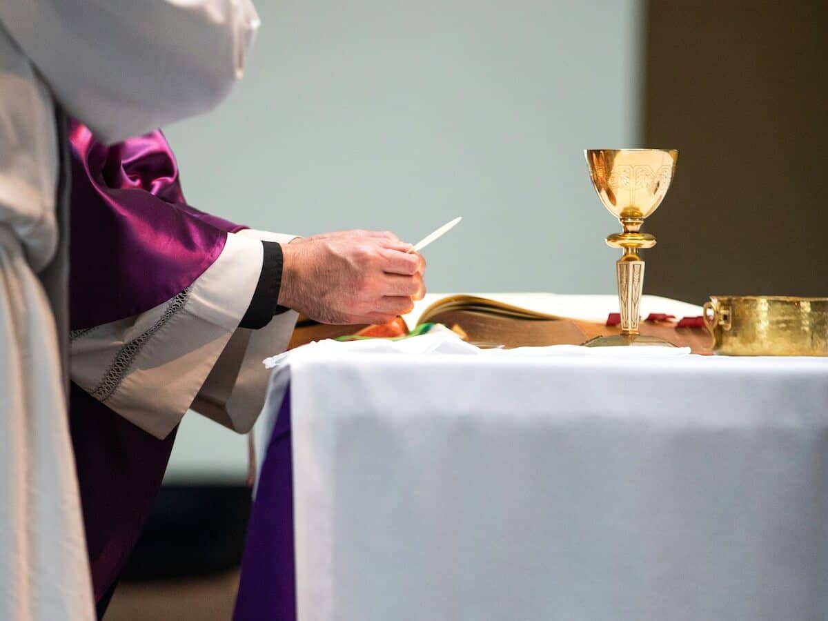 Eucharist Sacrament being celebrated at the alter with the body and blood of Christ