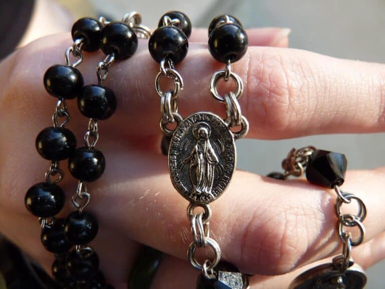 Rosary being held in someones hand