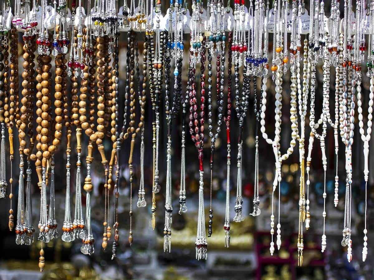 Dozens of rosaries hanging up.